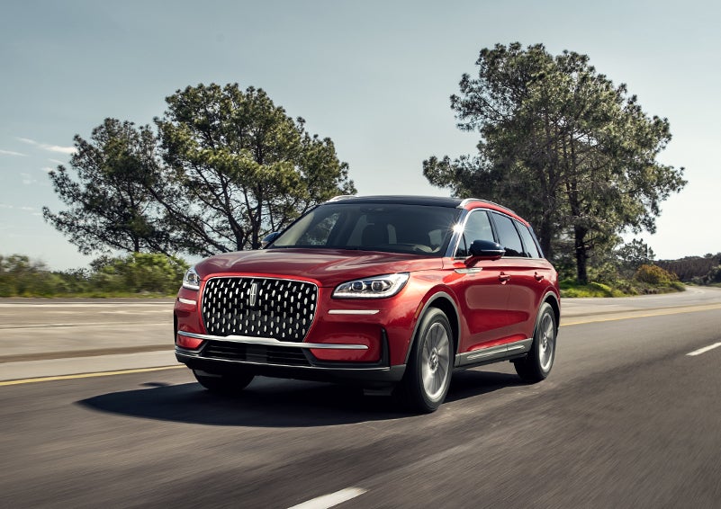A 2024 Lincoln Corsair® SUV is shown being driven on a country road. | Doral Lincoln in Doral FL