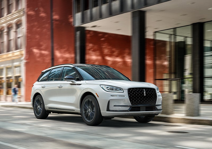 The 2024 Lincoln Corsair® SUV with the Jet Appearance Package and a Pristine White exterior is parked on a city street. | Doral Lincoln in Doral FL