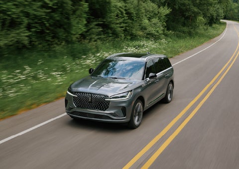 A 2027 Lincoln Aviator® SUV is being driven down a road. | Doral Lincoln in Doral FL