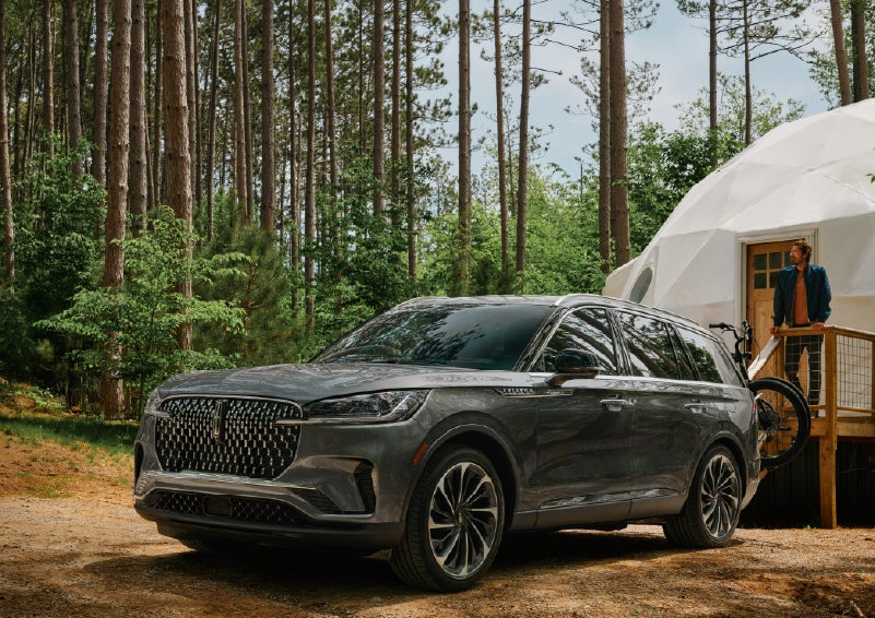 A 2027 Lincoln Aviator® is parked next to a high end glamping site. | Doral Lincoln in Doral FL