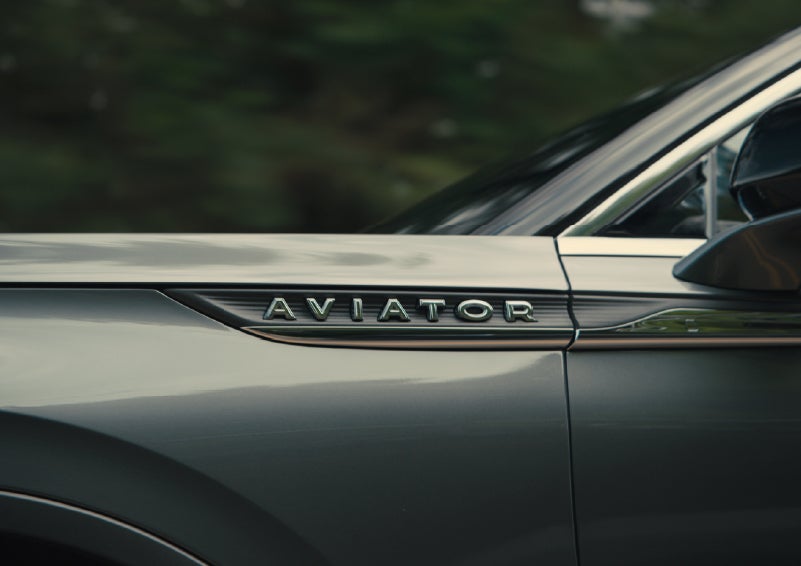 The driver’s side door and fender badging of a gray 2027 Lincoln Aviator® SUV are showcased. | Doral Lincoln in Doral FL