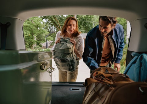 A couple loads luggage into the rear of a 2027 Lincoln Aviator® Black Label™ SUV..e 202 | Doral Lincoln in Doral FL