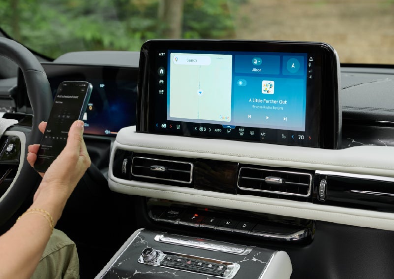 A person pairs thier phone with the center touchscreen of a 2027 Lincoln Aviator® Black Label™ SUV | Doral Lincoln in Doral FL